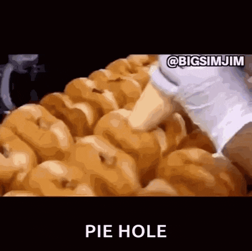 a bunch of donuts are sitting on top of each other with the words pie hole written in the corner .