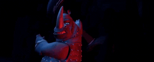 a close up of a cartoon character with red eyes .