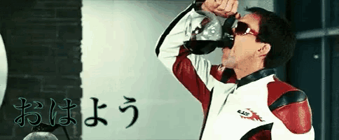 a man in a red and white jacket drinking from a cup