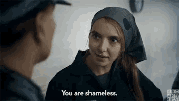 a woman with a scarf around her head is talking to a man and says you are shameless