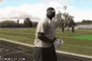 a man in a white shirt is running on a track .