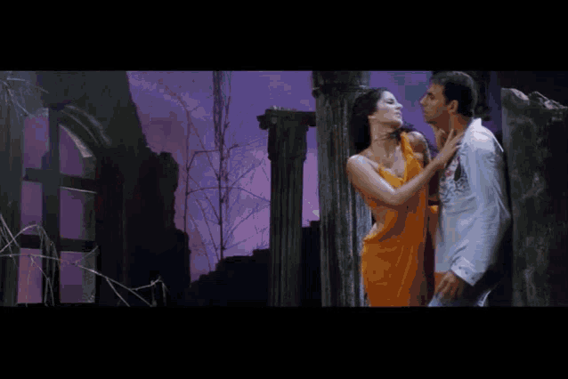 a woman in a yellow dress is dancing with a man on a bench