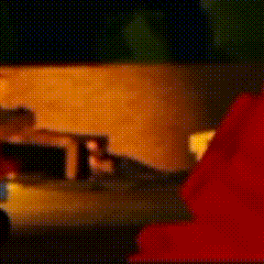 a cartoon character is standing next to a red couch in a room .