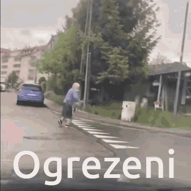 a picture of a man walking down a street with the word ogrezeni on the bottom