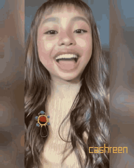a girl with her tongue out and the word cashreen behind her