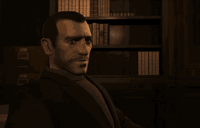 a man in a suit is sitting in front of a bookshelf and says i 'm sorry to hear that