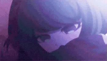 a close up of a person 's face in a dark room with purple lights .