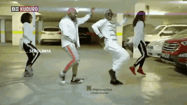 a group of people are dancing in a parking garage with the words be kuduro in the background