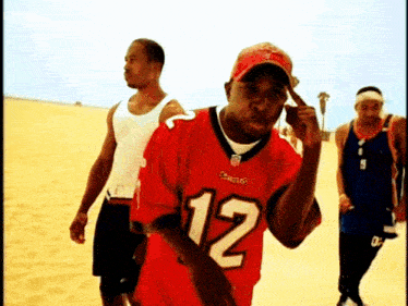 a man wearing a red jersey with the number 12