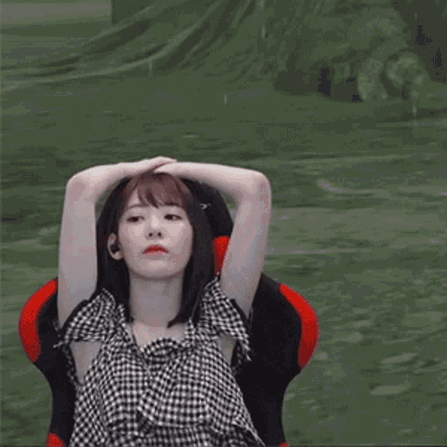a woman is sitting in a chair in front of a computer screen .