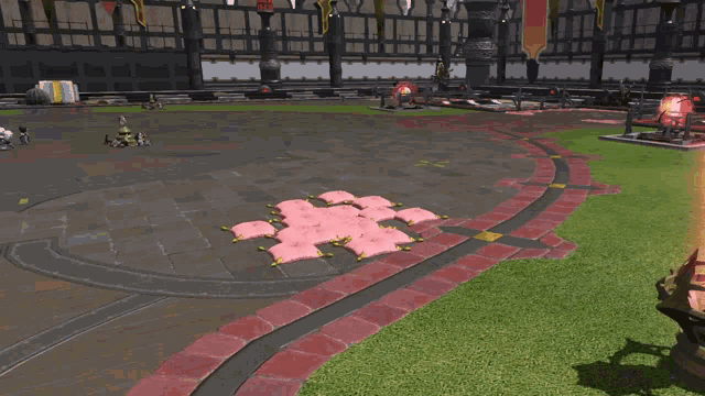 a bunch of pink pillows are sitting on a lush green field