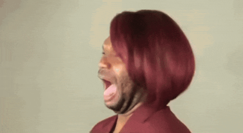 a man with red hair and a beard is making a face .