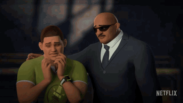 a man in a suit and tie is standing next to a man in a green shirt with a watch on his wrist