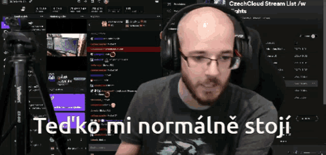 a man wearing headphones says ted ko mi normalne stoji in front of a computer screen