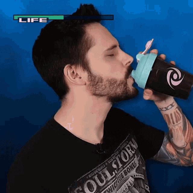 a man drinking from a shaker with the word life above him