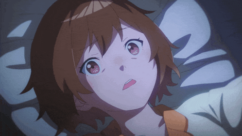 a girl with brown hair is laying on a bed and looking up
