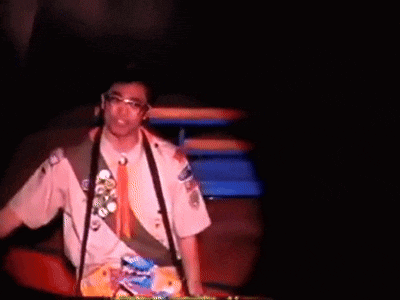 a man in a boy scout uniform has a badge that says ' scout ' on it