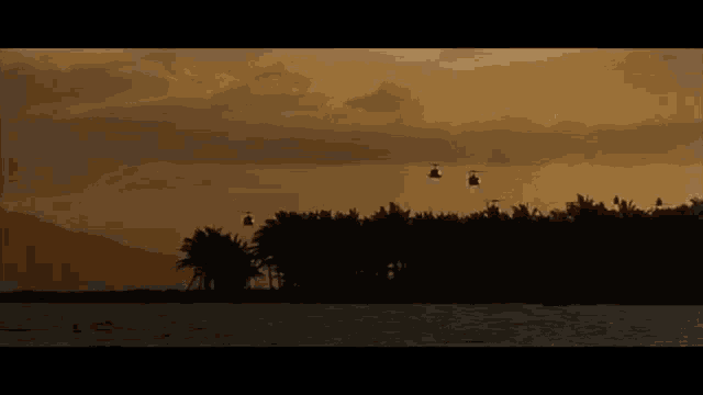 a few helicopters are flying over a tropical island