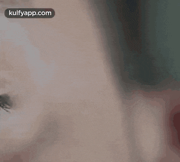 a close up of a man 's face in a dark room