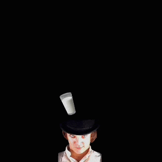 a glass of milk is being poured into a man 's head