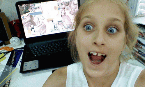 a girl is taking a selfie in front of a laptop that says dell