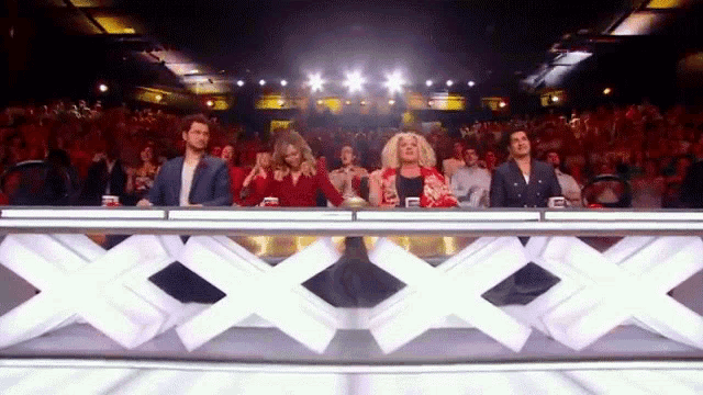 a group of people are sitting at a table with an x on it