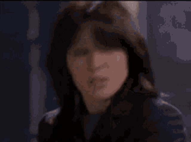 a woman is looking at herself in a mirror in a bathroom .