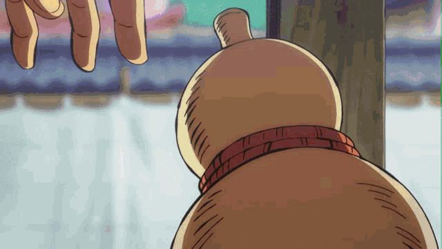 a cartoon character with a red collar is being held by someone 's hand