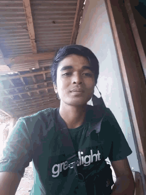 a man wearing a green shirt that says green light