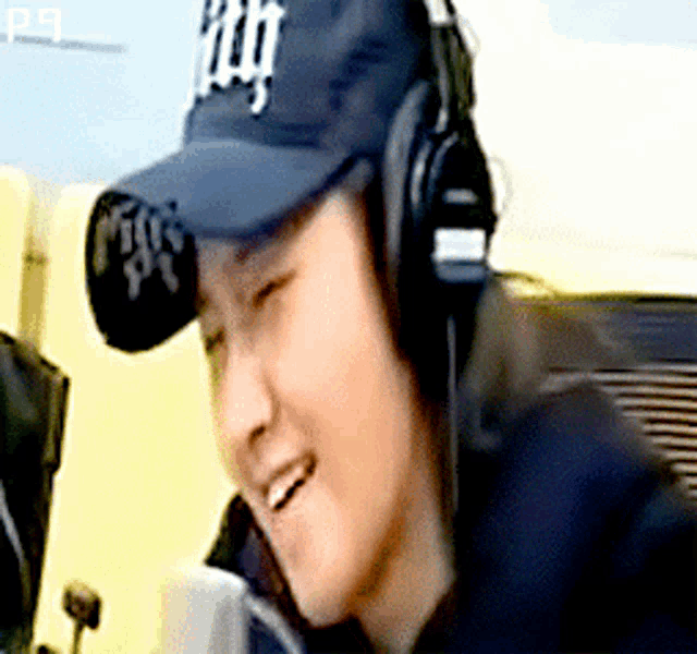 a person wearing headphones and a ny hat