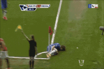 a soccer player is laying on the field during a game against chelsea