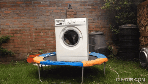 a washing machine sitting on top of a trampoline with gifrun.com written below it