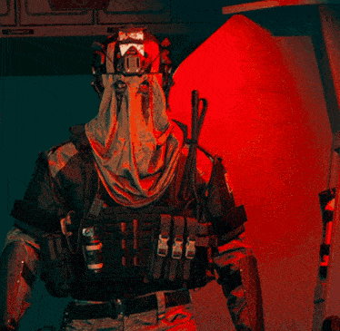 a man with a mask on his face is standing in front of a red no smoking sign