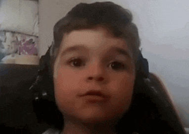 a close up of a young boy wearing headphones .
