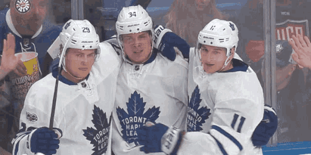 three toronto maple leafs players posing for a picture