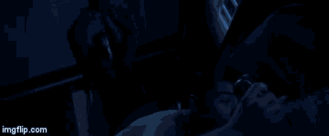 a shirtless man is laying on a bed with a can of soda in his hand and a ghost behind him .
