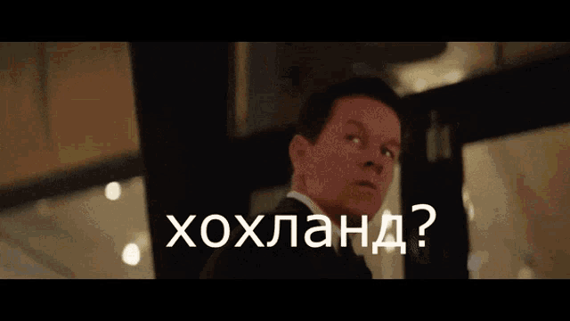 a man in a suit stands next to another man with the words " ну нахуй " written on the bottom
