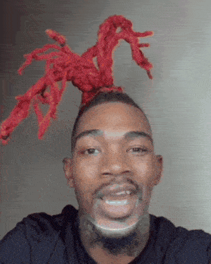 a man with red dreadlocks on his head