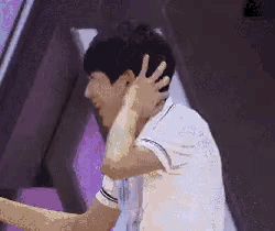 a man in a white shirt is hugging another man .