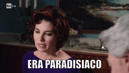 a woman in a purple dress is talking to a man and says era paradisiaco