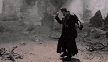 a man in a long black coat is holding a sword