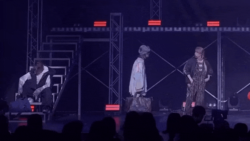 a group of people are performing on a stage in front of a crowd .
