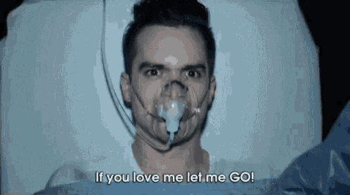 a man is laying in a hospital bed with an oxygen mask on his face and says `` if you love me let me go '' .