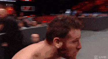 a man with a beard is wrestling in a ring .