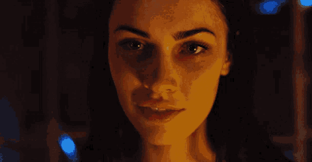 a close up of a woman 's face with her eyes closed