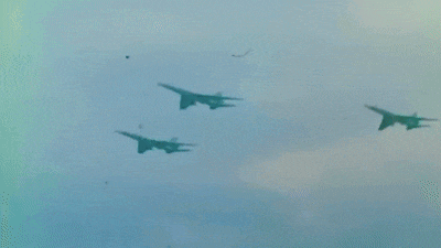 two fighter jets are flying side by side in the sky