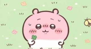 a pink hamster is holding a green clover in its mouth .