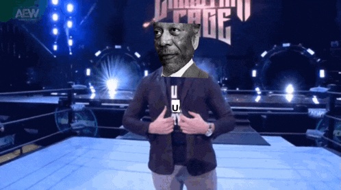 a man in a suit stands in front of a sign that says aew on it