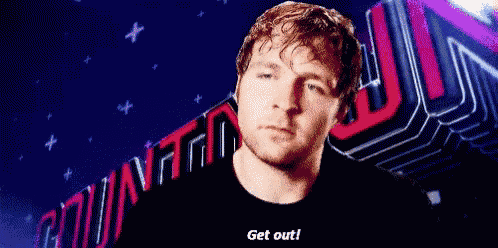 a man in a black shirt is standing in front of a sign that says get out .
