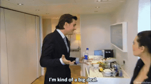 a man in a suit says i 'm kind of a big deal while standing next to a woman